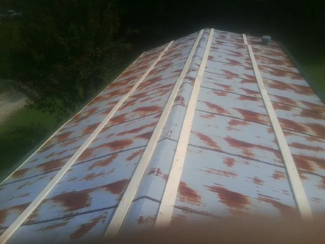 Rusted metal roof panels with new wood purlins before replacement — Storm Damage Roof Repair in Mc Lean by Roofing Brothers
